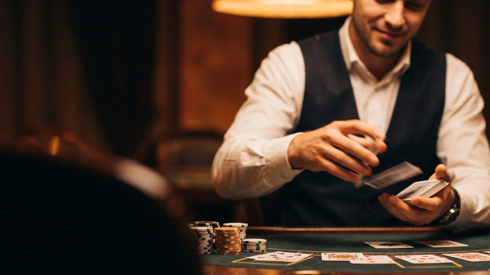 Luxury live casino table with cards, chips and warm gold lighting